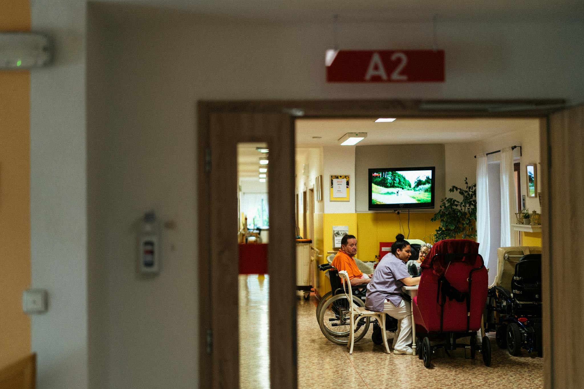 Healthcare professionals caring for elderly patients in a hospital setting, emphasizing support and care.